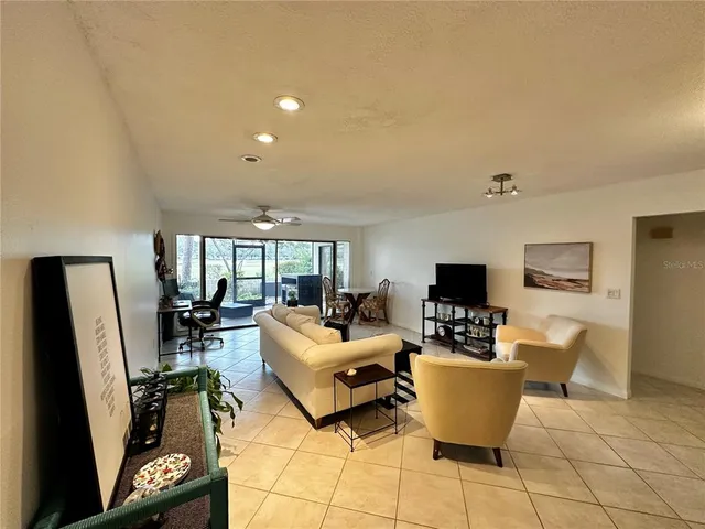 a living room with fireplace furniture and a flat screen tv
