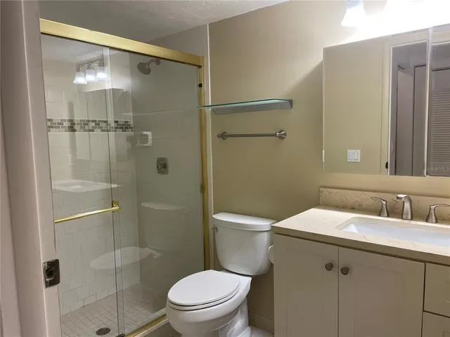 a bathroom with a toilet a sink and shower