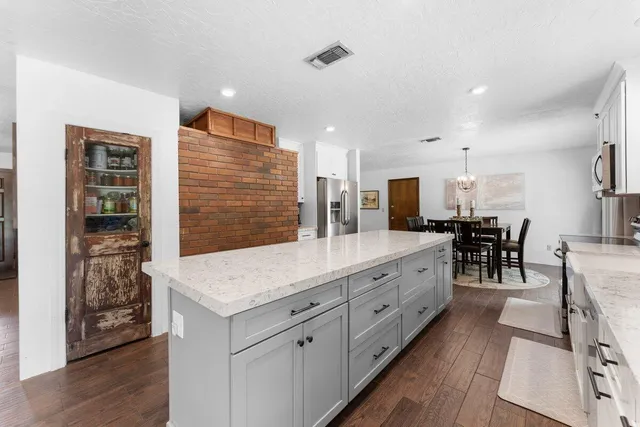 a kitchen with lots of counter top space and cabinets