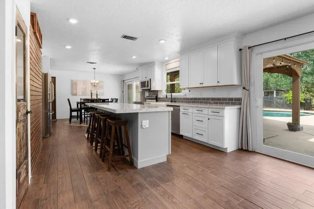 a living room with furniture and a kitchen