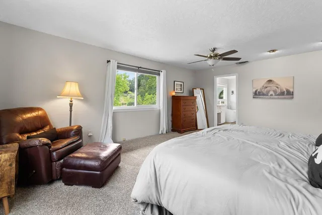 a bedroom with a large bed and a chandelier