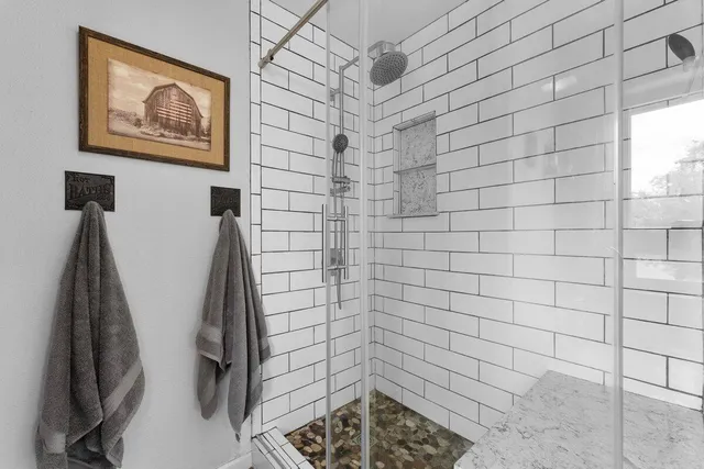 a bedroom with a bed dresser and a window