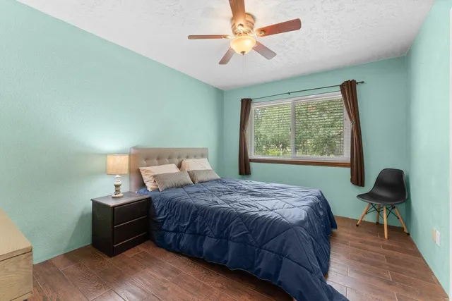 a bedroom with furniture and a large window