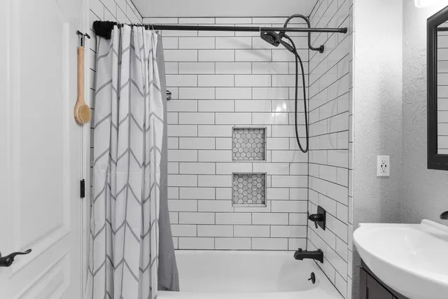 a bathroom with 2 sink and a mirror