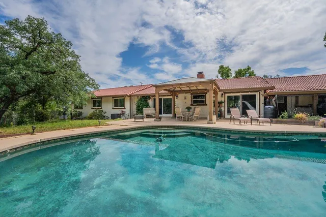 a front view of a house with a yard table and chairs