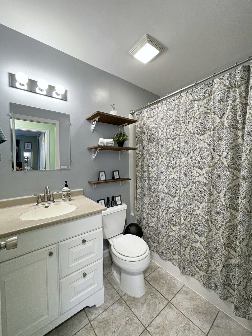 35 Winrock Road Montgomery, IL 60538 - Photo 22 of 37 a bathroom with a granite countertop sink a toilet and a mirror