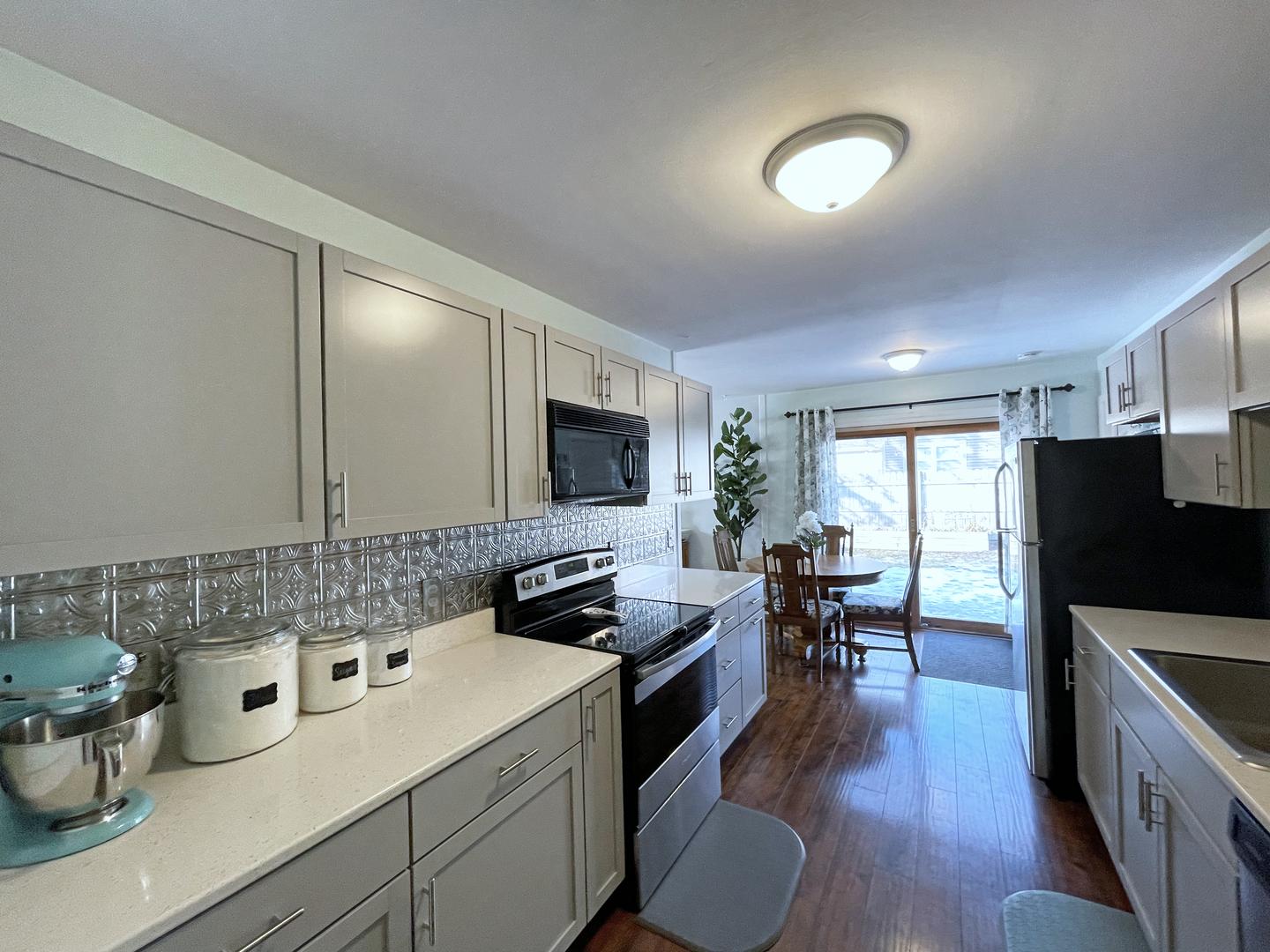 35 Winrock Road Montgomery, IL 60538 - Photo 9 of 37 a view of a kitchen area with furniture and wooden floor
