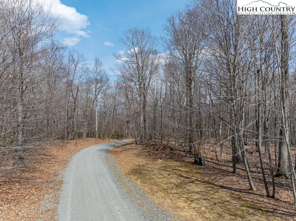 a view of a dry yard with mountains in the background