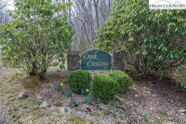 a sign board with yard in the back