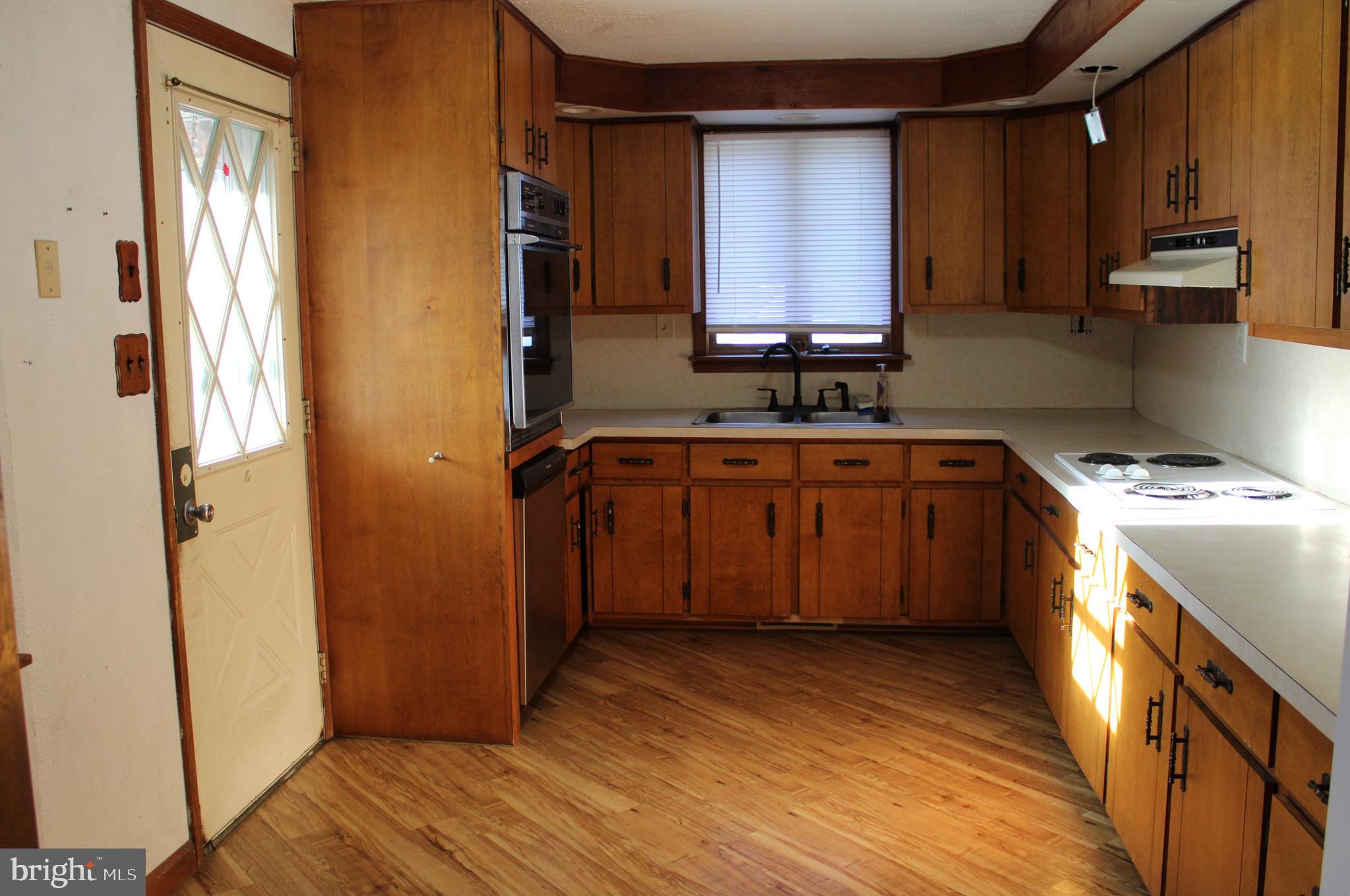 2456 Seven Valleys Road, Unit 1 Seven Valleys, PA 17360 - Photo 2 of 7 a kitchen with stainless steel appliances granite countertop a sink stove and refrigerator