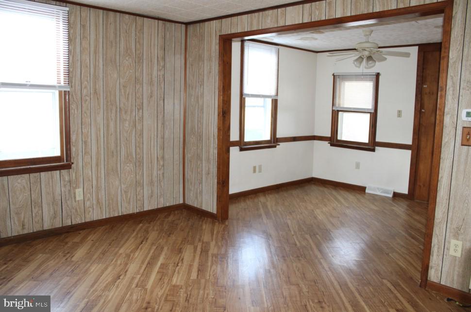 2456 Seven Valleys Road, Unit 1 Seven Valleys, PA 17360 - Photo 4 of 7 an empty room with wooden floor and windows