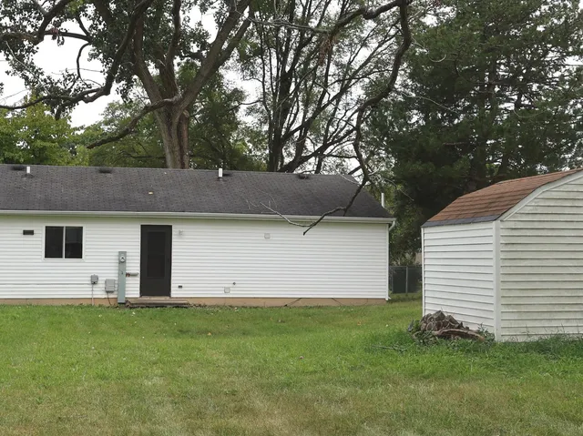 a view of house with backyard
