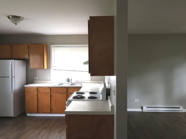 a kitchen with a sink a stove and refrigerator