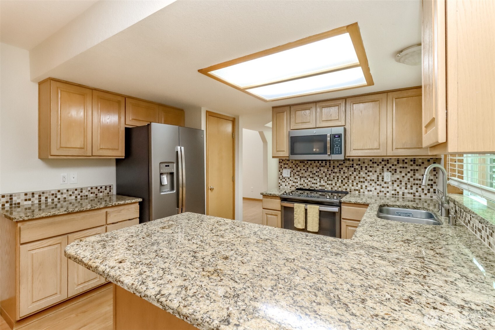 5475 Park Pl Loop Southeast Lacey, WA 98503 - Photo 11 of 40 a kitchen with stainless steel appliances granite countertop a sink stove and refrigerator