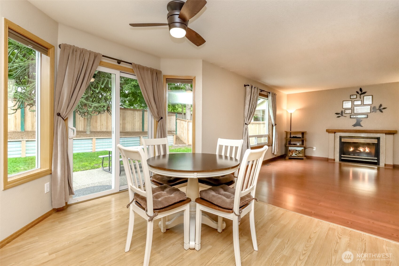 5475 Park Pl Loop Southeast Lacey, WA 98503 - Photo 13 of 40 a dining room with furniture a fireplace and wooden floor