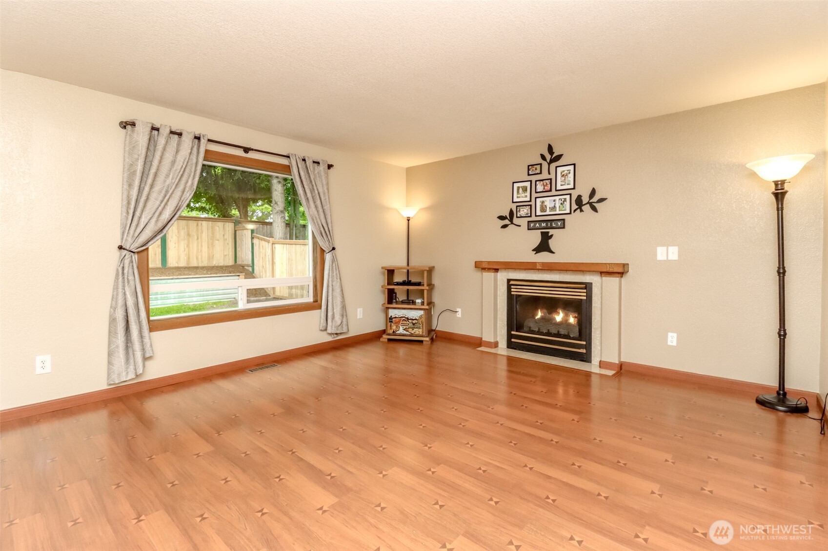 5475 Park Pl Loop Southeast Lacey, WA 98503 - Photo 14 of 40 wooden floor fireplace and windows in an empty room