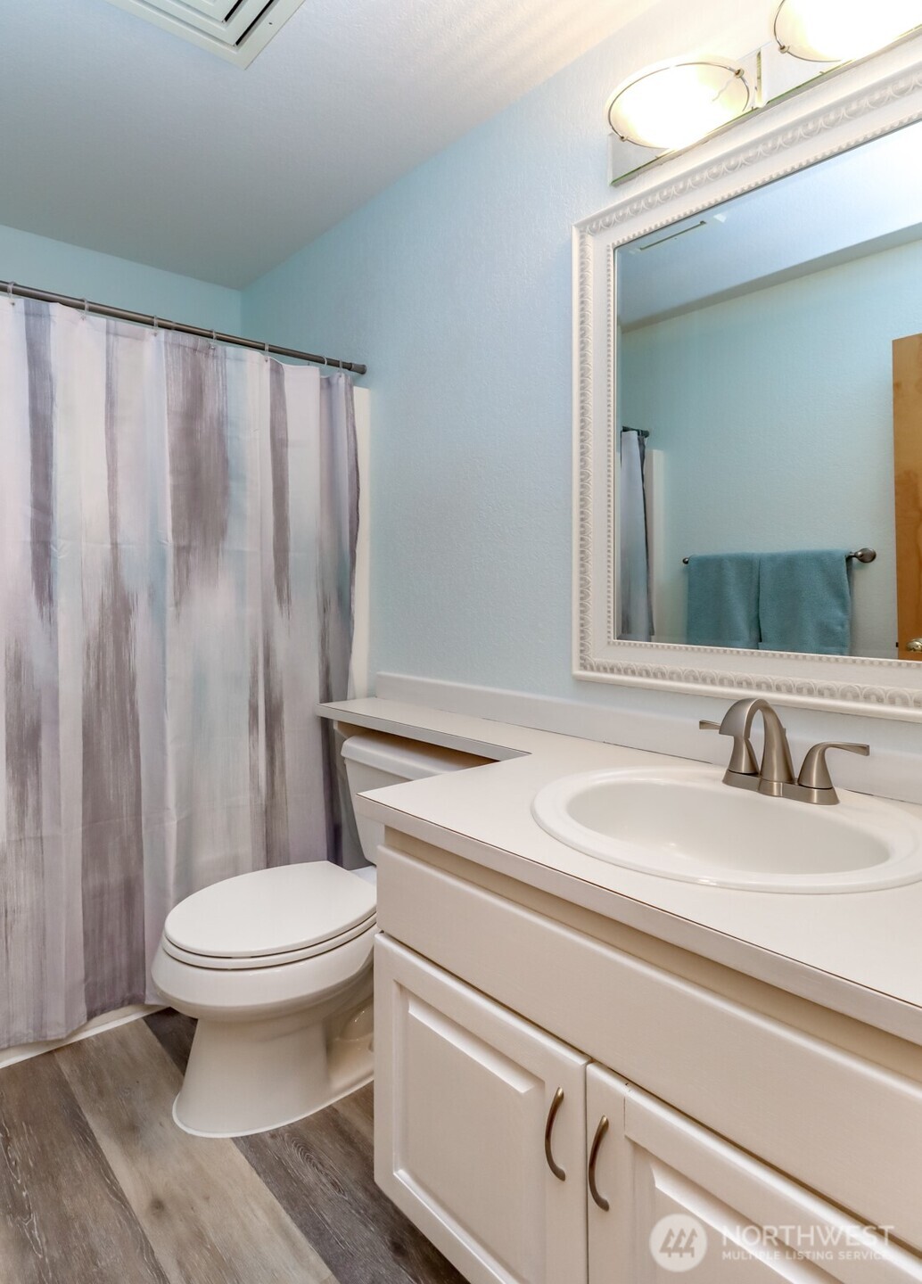 5475 Park Pl Loop Southeast Lacey, WA 98503 - Photo 20 of 40 a bathroom with a sink a toilet and a mirror