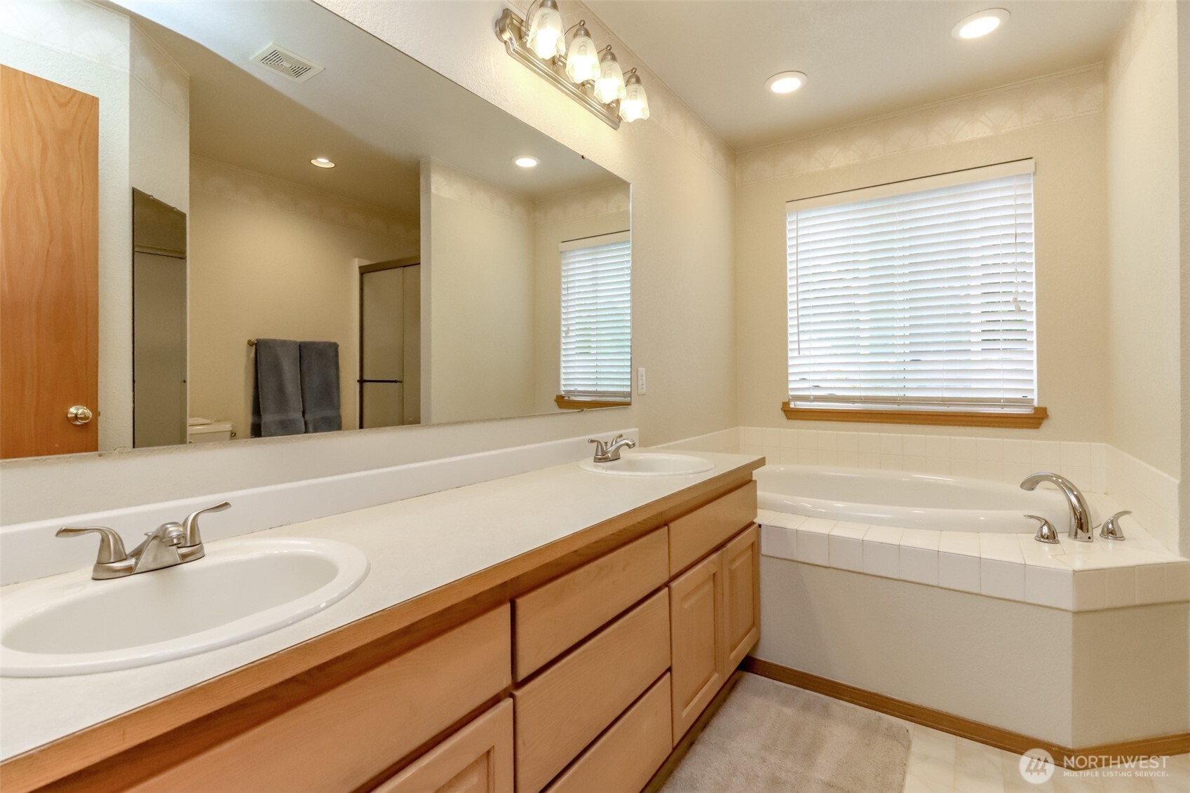 5475 Park Pl Loop Southeast Lacey, WA 98503 - Photo 26 of 40 a bathroom with a double vanity sink a mirror and a bathtub