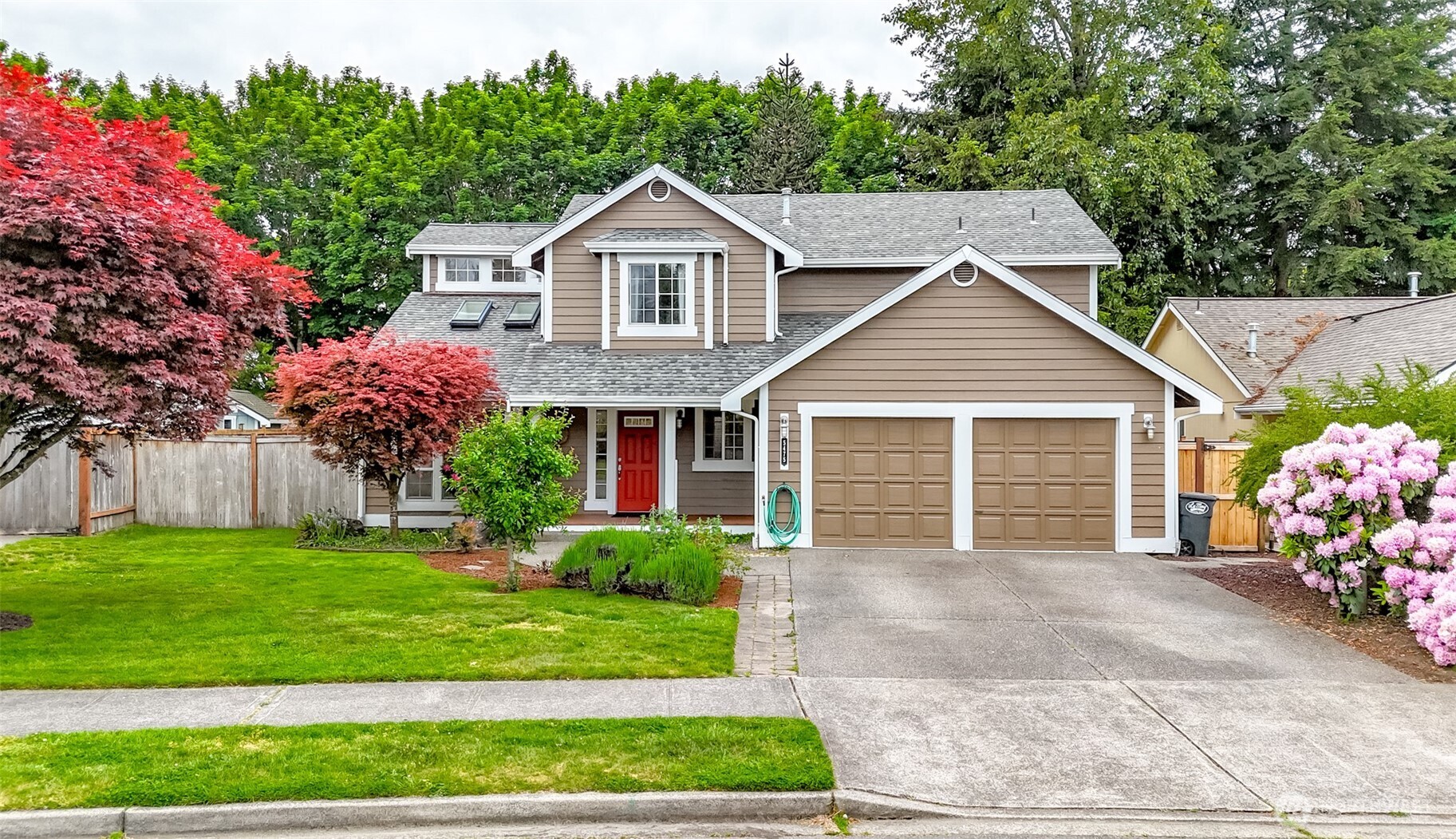 5475 Park Pl Loop Southeast Lacey, WA 98503 - Photo 36 of 40 a front view of a house with a yard and garage
