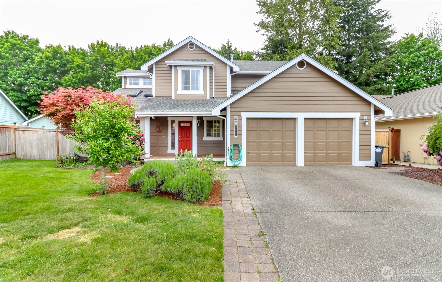 5475 Park Pl Loop Southeast Lacey, WA 98503 - Photo 39 of 40 a front view of a house with a yard and garage