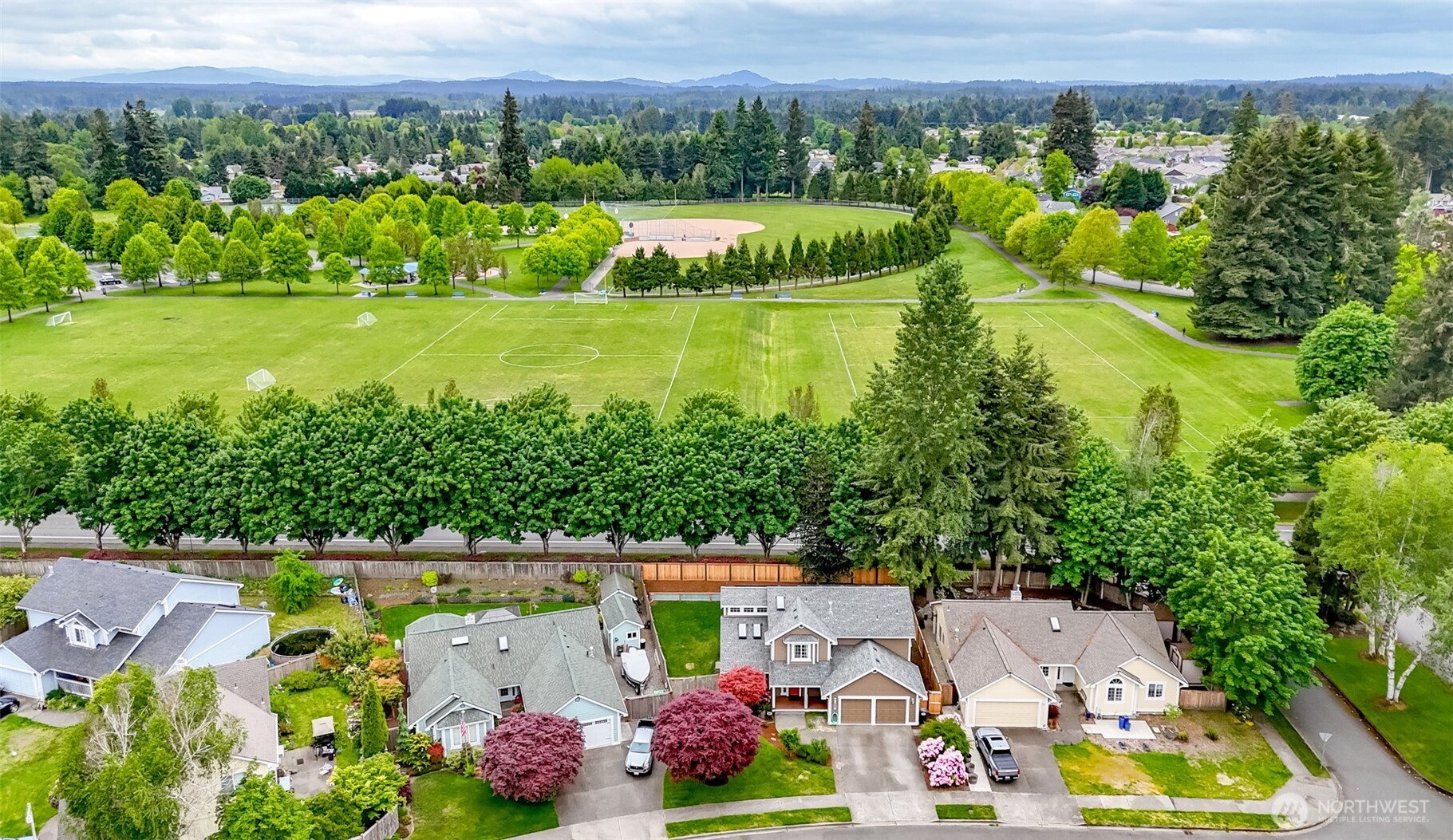 5475 Park Pl Loop Southeast Lacey, WA 98503 - Photo 5 of 40 an aerial view of a house with a garden and lake view