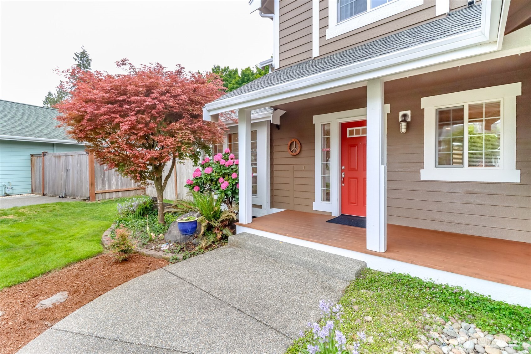5475 Park Pl Loop Southeast Lacey, WA 98503 - Photo 6 of 40 a front view of a house with a yard and potted plants