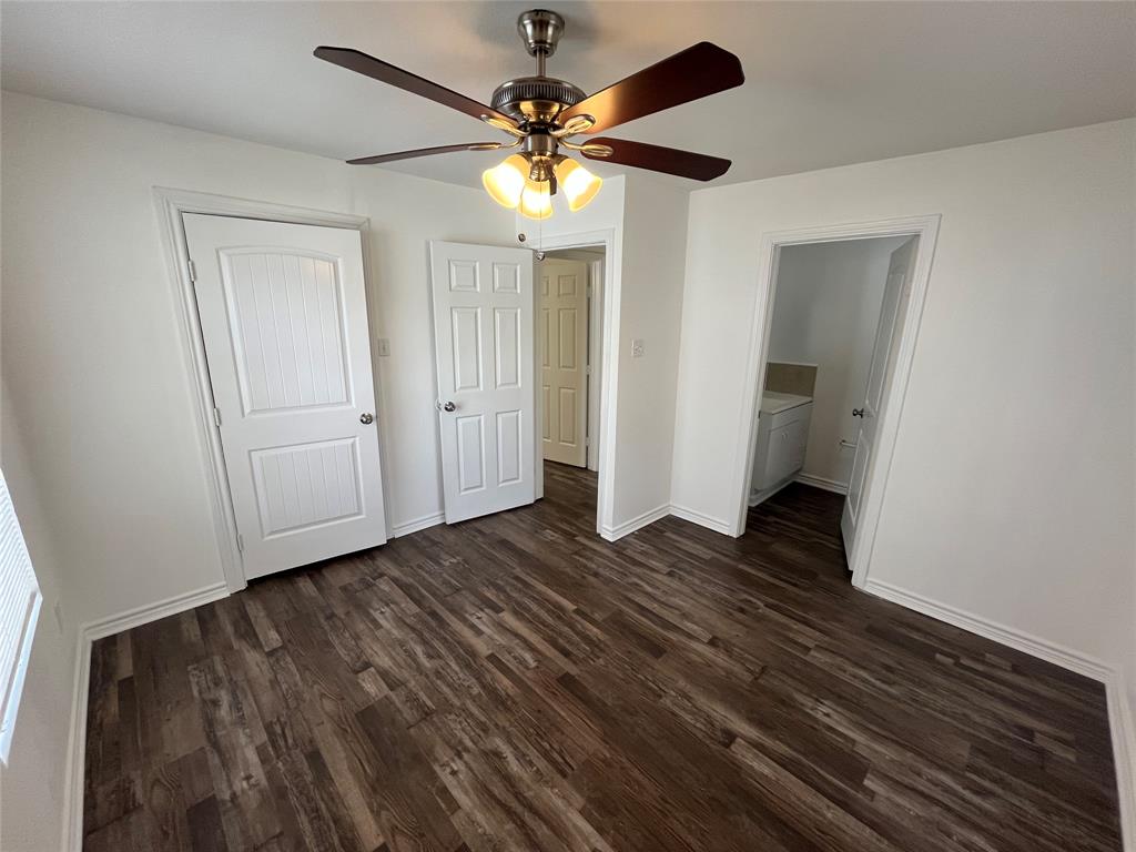 1107 Calle Real Mesquite, TX 75149 - Photo 14 of 24 a view of an empty room with wooden floor and a ceiling fan