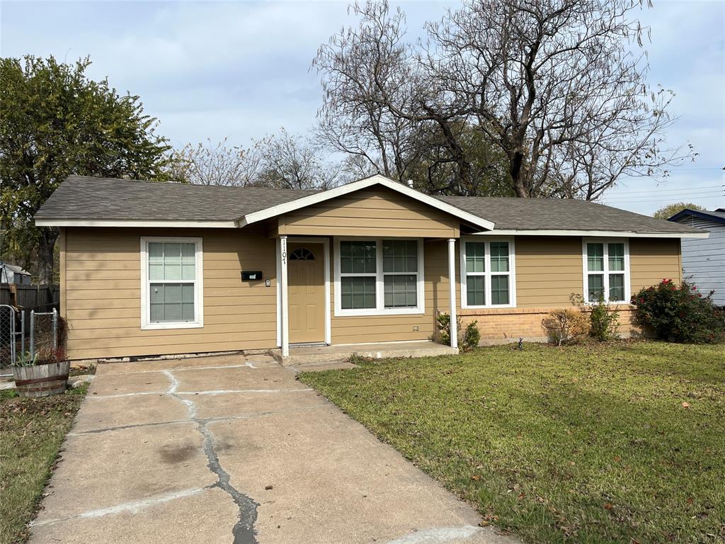 1107 Calle Real Mesquite, TX 75149 - Photo 2 of 24 a front view of a house with a garden and yard