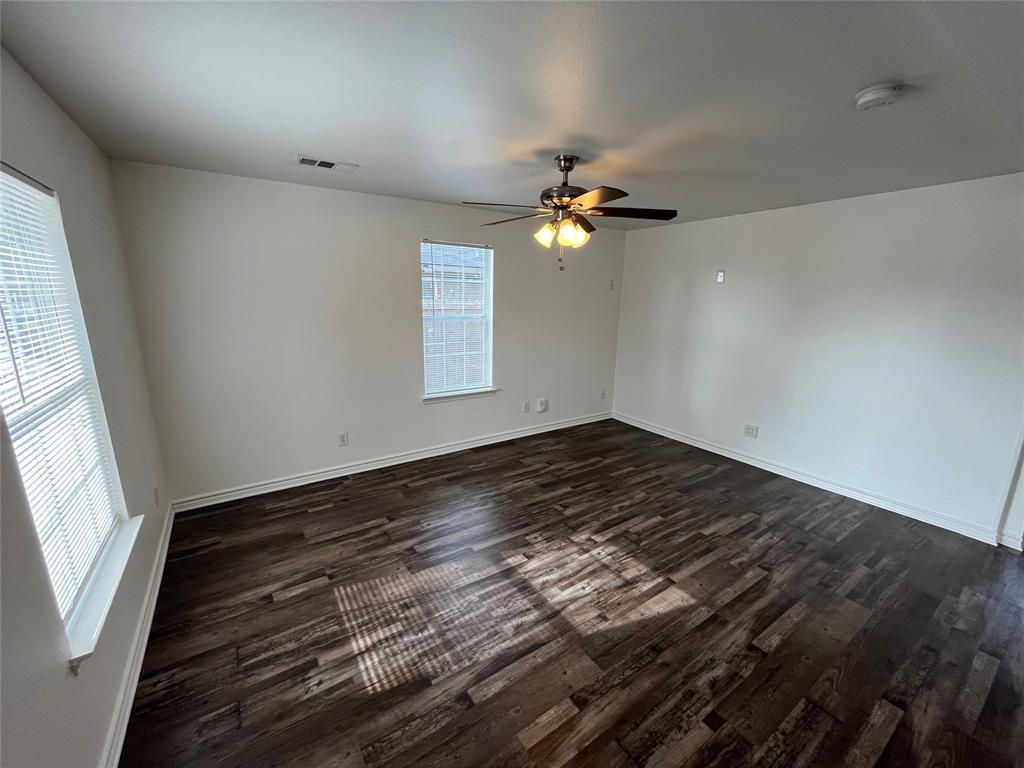 1107 Calle Real Mesquite, TX 75149 - Photo 4 of 24 wooden floor in an empty room with a window