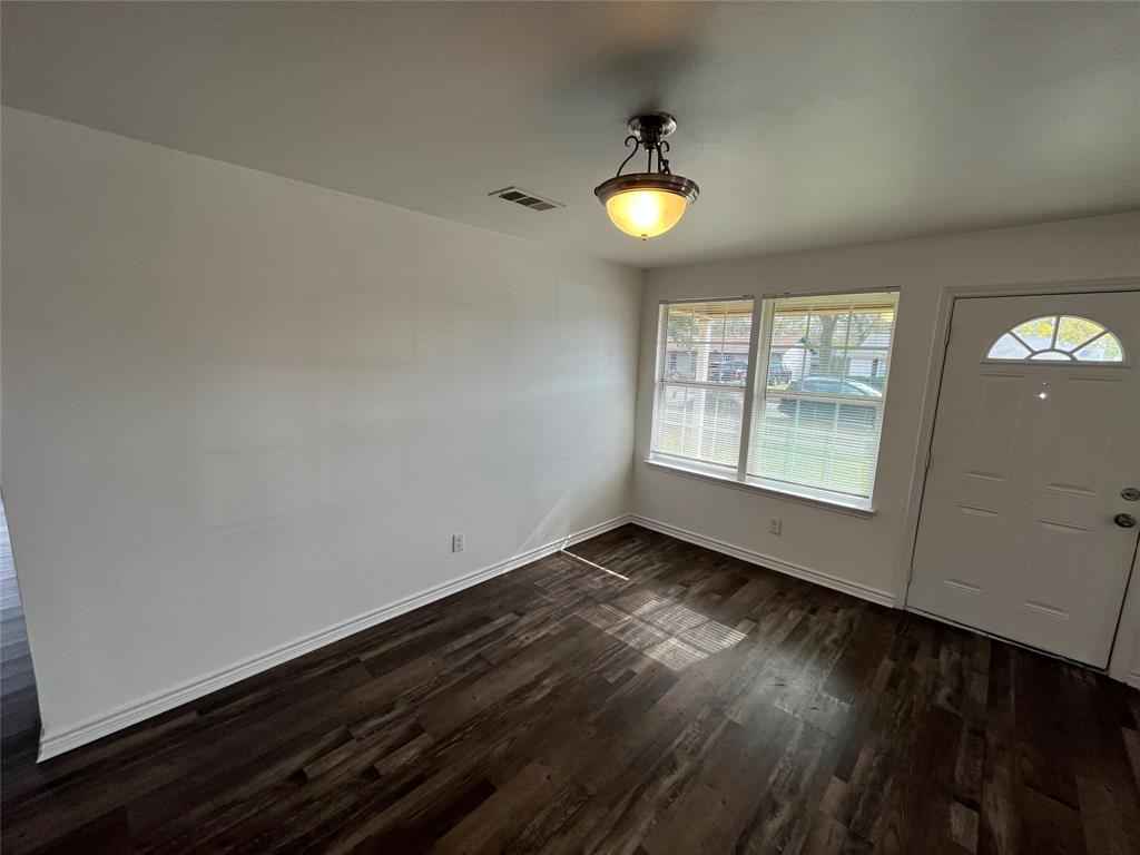 1107 Calle Real Mesquite, TX 75149 - Photo 6 of 24 an empty room with wooden floor and windows