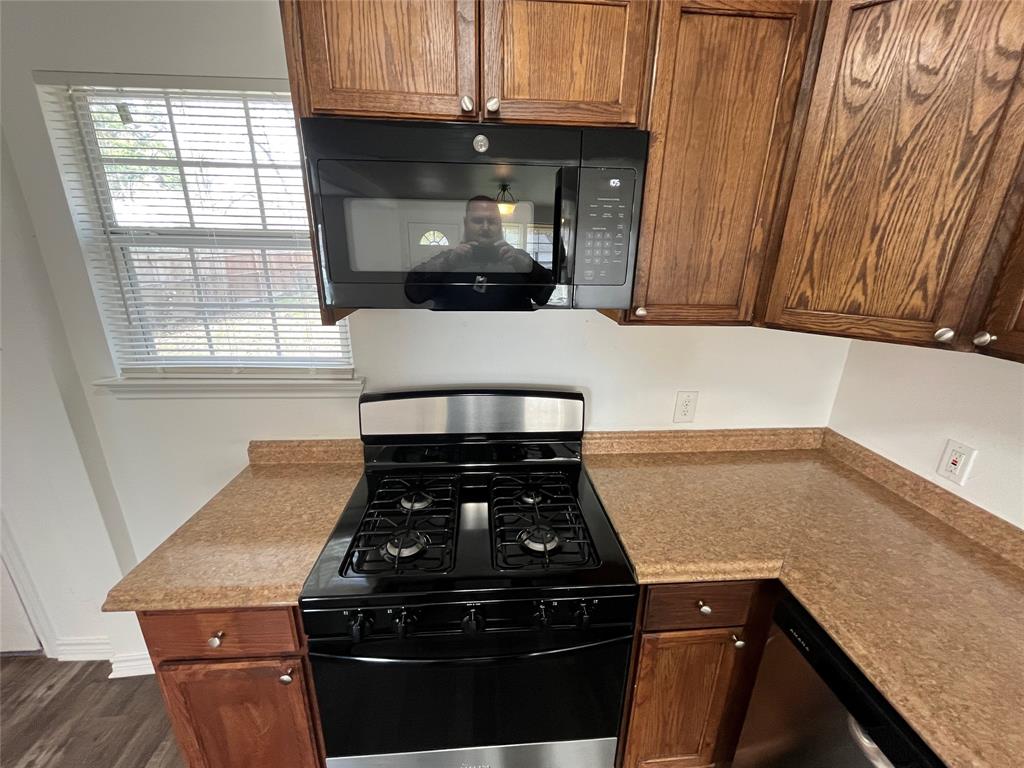 1107 Calle Real Mesquite, TX 75149 - Photo 10 of 24 a kitchen with a stove and a cabinet