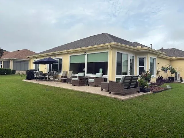 a front view of building with outdoor seating and yard