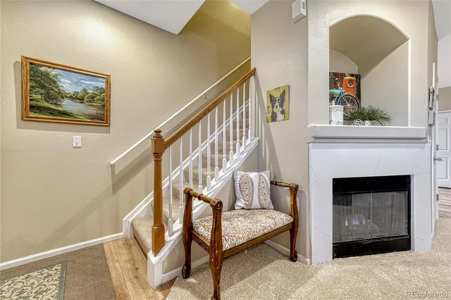 a living room with a fireplace and a potted plant