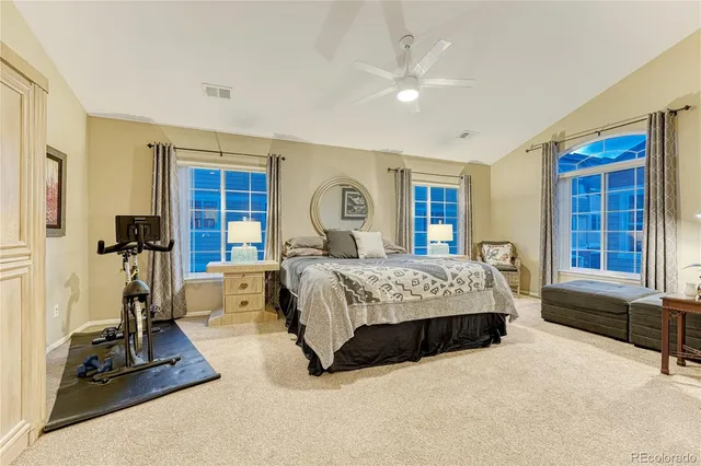 a bedroom with a bed and a large window