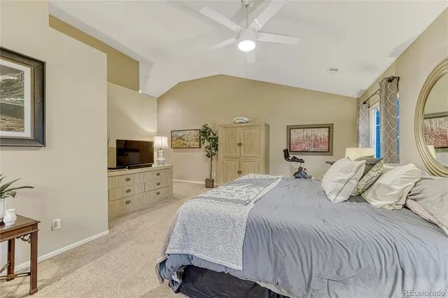 a bed room with a bed a television and dresser