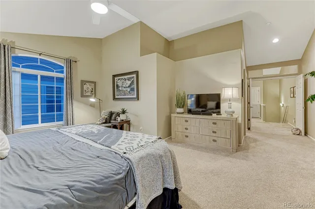 a view of a bedroom with cabinet flat screen tv and windows