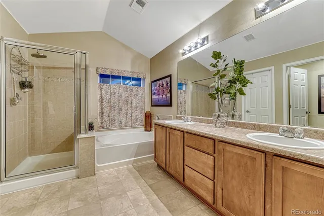a bathroom with a granite countertop sink a mirror and a shower