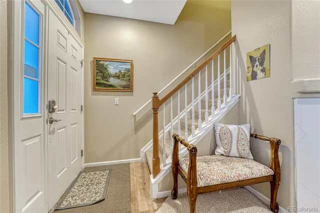 a view of entryway with wooden floor and stairs