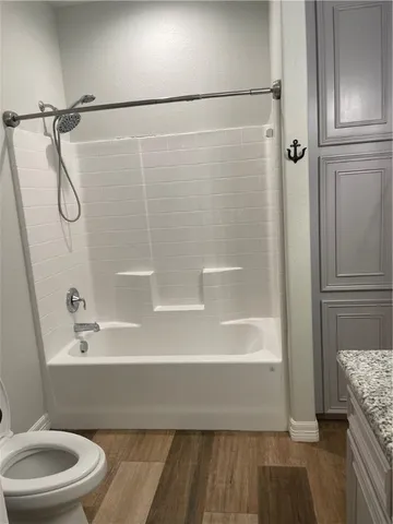 a bathroom with a toilet and a shower