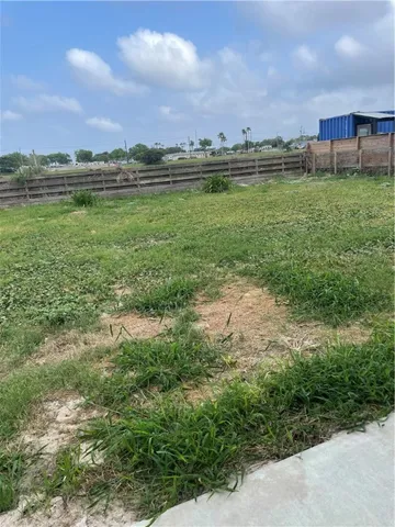 a view of a lake with houses in the back