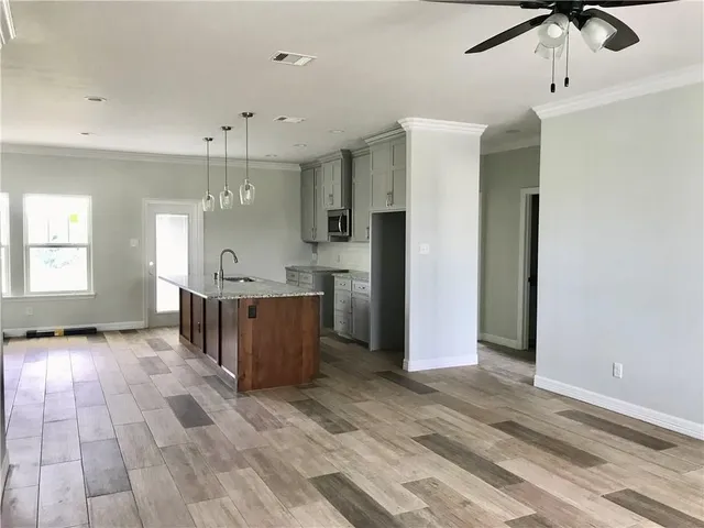 a view of a kitchen with a refrigerator and a window