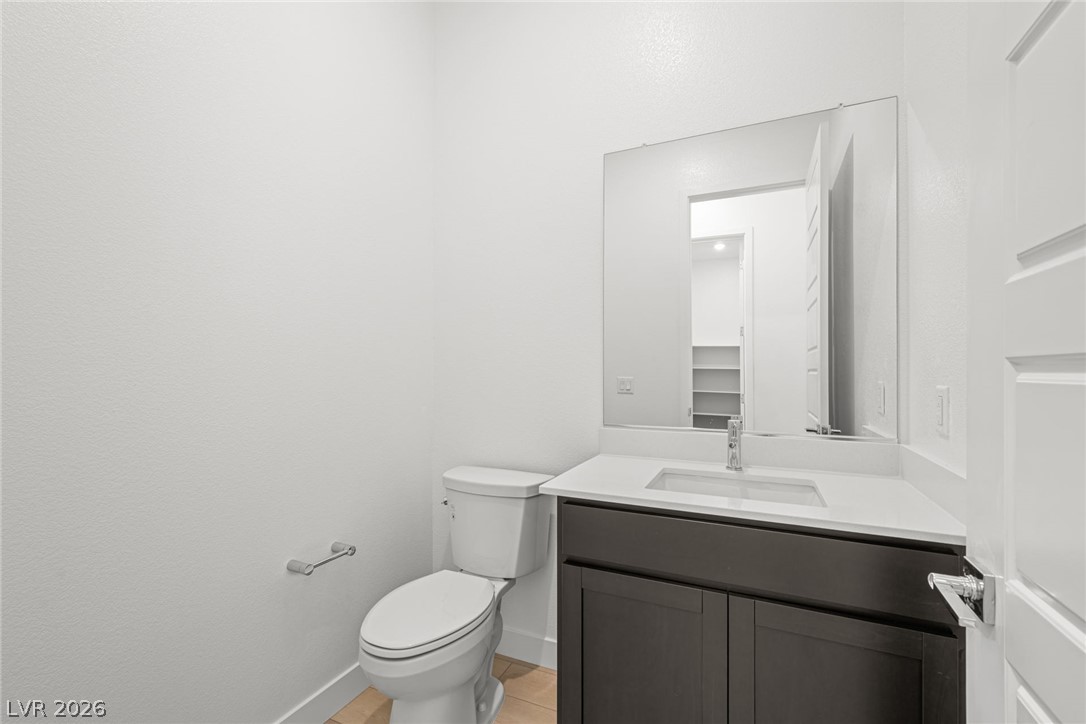 9983 Decano Ridge Street Las Vegas, NV 89141 - Photo 20 of 39 A well-appointed powder room features a sleek vanity with ample counter space.