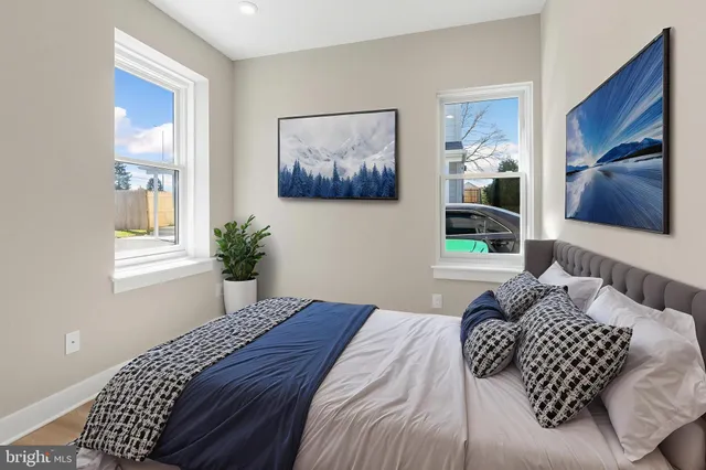 a bedroom with a bed and a painting on the wall