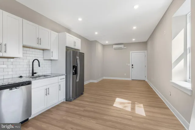 a kitchen with stainless steel appliances granite countertop a refrigerator and a sink
