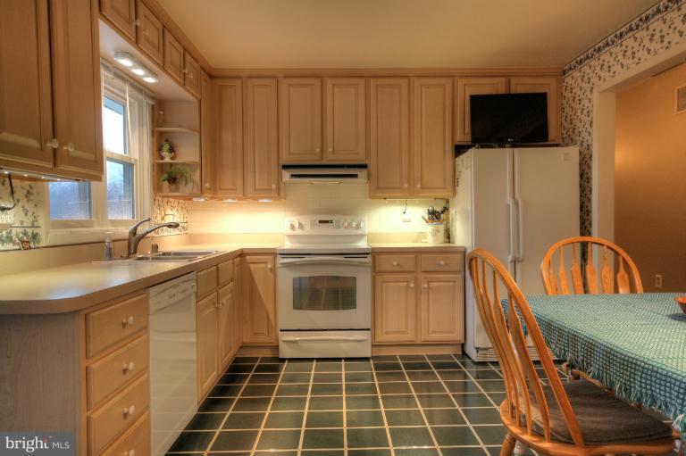 2711 Hunting Ridge Court Baldwin, MD 21013 - Photo 11 of 26 a kitchen with stainless steel appliances a stove a sink a microwave a refrigerator and cabinets