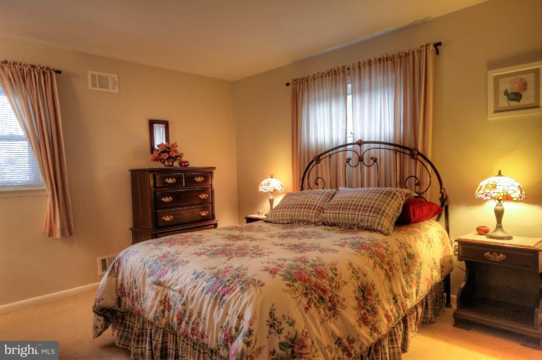 2711 Hunting Ridge Court Baldwin, MD 21013 - Photo 12 of 26 a bedroom with a bed and wooden floor