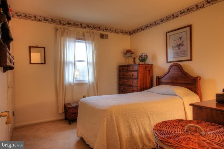 2711 Hunting Ridge Court Baldwin, MD 21013 - Photo 16 of 26 a bedroom with a bed and a painting on the wall