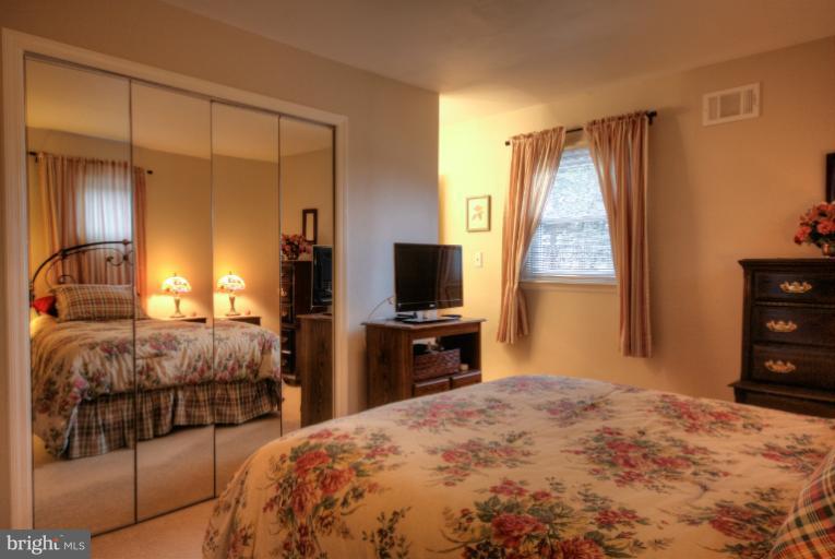 2711 Hunting Ridge Court Baldwin, MD 21013 - Photo 23 of 26 a bedroom with a bed and a flat screen tv
