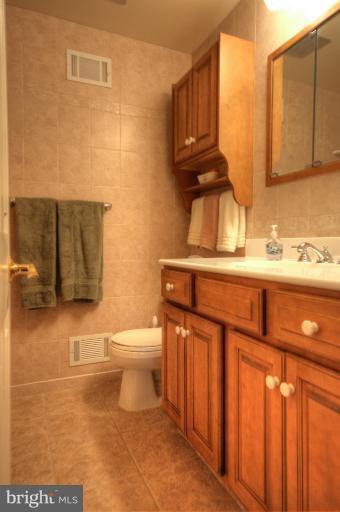 2711 Hunting Ridge Court Baldwin, MD 21013 - Photo 24 of 26 a bathroom with a sink a toilet and mirror