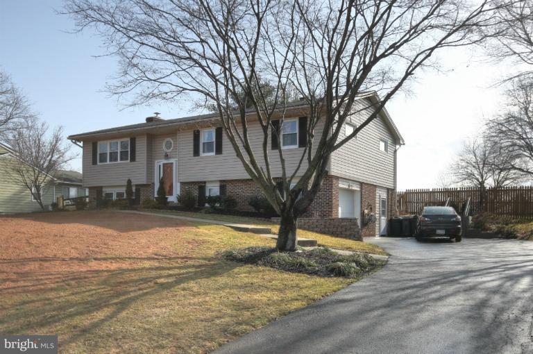 2711 Hunting Ridge Court Baldwin, MD 21013 - Photo 26 of 26 a front view of a house with a yard covered with snow
